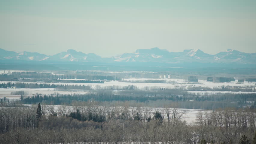 Pan across Alberta mountain range off in the distance