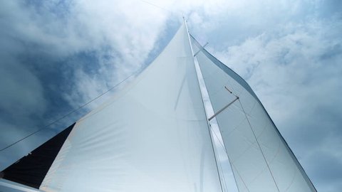 Sailing in the wind. Full sails, very strong wind. Ocean race, real adventure. Storm day. Sun sails, and adventure.
