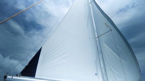 Sailing in the wind. Full sails, very strong wind. Ocean race, real adventure. Storm day. Sun sails, and adventure.
