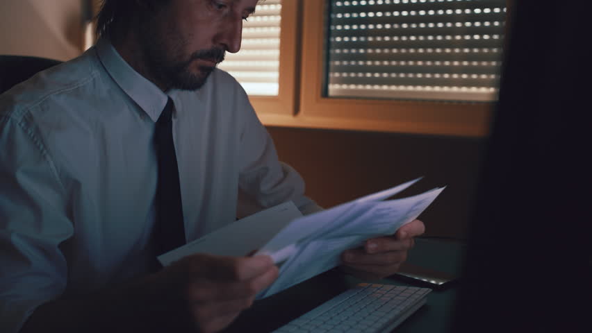 Businessman reading letter in office