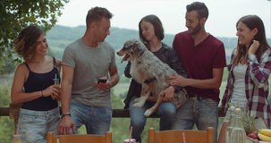 group of friends having a break in the countryside  with a funny dog. shot in slow motion