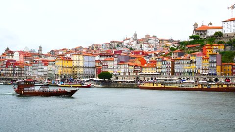 Porto, Portugal skyline time lapse on the Douro River with traditioanl gondolas 