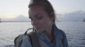 Closeup portrait of happy tourist woman enjoying boat ride during sunset - video in slow motion