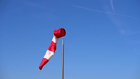 Slow motion of a wind sock swinging in a strong wind