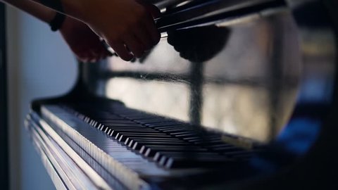 Close up shot of a artist opening a white piano