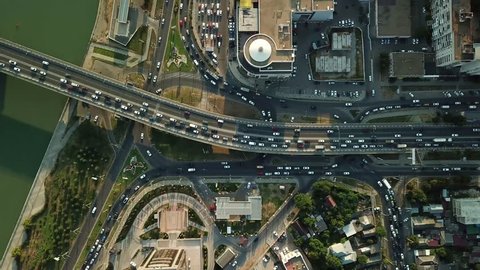 Aerial Drone Flight View of freeway busy city rush hour heavy traffic jam highway, .  Aerial view of the vehicular intersection,  traffic at peak hour with cars on the road and on the bridge.