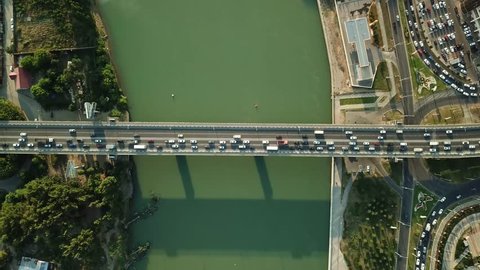 Aerial Drone Flight View of freeway busy city rush hour heavy traffic jam highway.  Aerial view of the vehicular intersection,  traffic at peak hour with cars on the road and on the bridge.