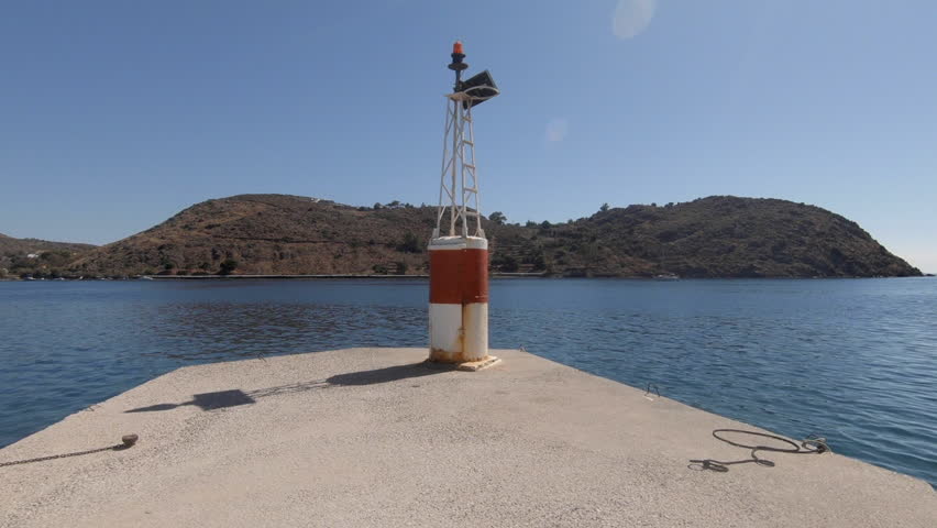 Camera pans fron buoy to the harbour of Skala on the Greek island of Patmos