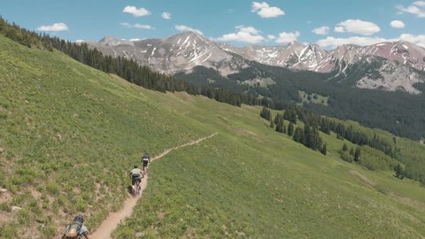 Flying Chase Shot of Mountain BIkers Cruising Down a Trail in Crested Butte Colorado