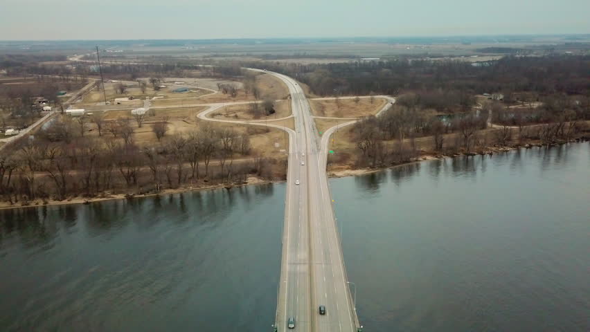 BURLINGTON, IOWA - CIRCA 2017 - Aerial of a suspension bridge crossing the Mississippi River near Burlington, Iowa suggests American infrastructure.