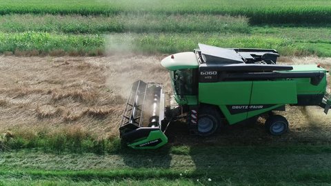 Reggio Emilia / Italy - 07/05/2018: wheat combine harvester at work in a field of wheat