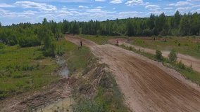 10 June 2018 Russian Federation, Bryansk region, Ivot - Extreme sports, cross-country motocross. . Aerial and video in motion. Camera in motion. Tracking a man riding a