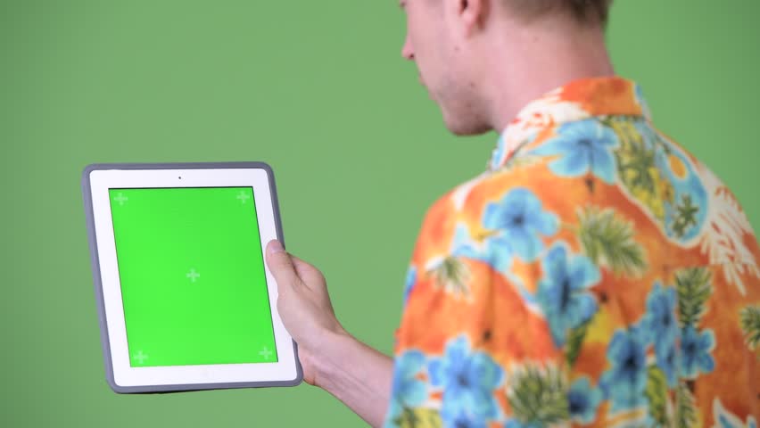 Young handsome tourist man using digital tablet