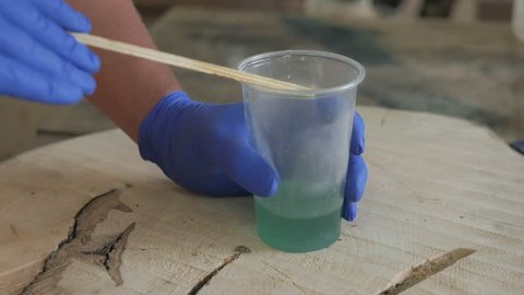 epoxy resin. The woodworker pours the table top with epoxy resin. 4k