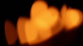 Heart shape of candles light in dark abstract blur background
