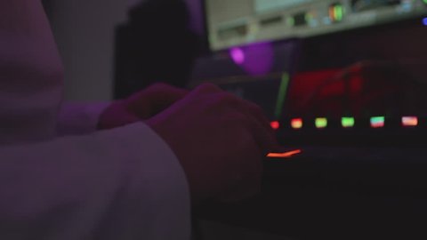 Music producer making a beat in dark room
