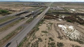 Flight over long highway at monument valley in Utah - Drone Aerial over cars in Arizona. Top view drone footage flying over dry and beige desert, drought resulted landscape, global warming threat