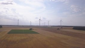 4k AERIAL footage with windmills on wind-farm and summer fields. 3840x2160, 30fps, 