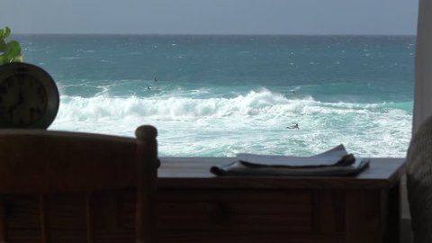 Surfers house from inside. home with ocean view watching surfers from inside in the living room. View from bed over the ocean seeing surfers riding. Dream surf house on the beach. 