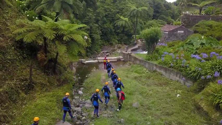 Canyon with a group of yellow-helmed people aerial shot