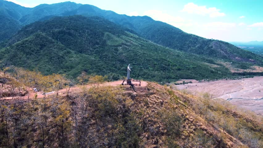 Aerial drone video of Christ the Redeemer on top a mountain in the Philippines, Asia.