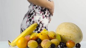 Beautiful woman choosing fruits. Healthy eating. Weight loss and dieting concept. slow motion