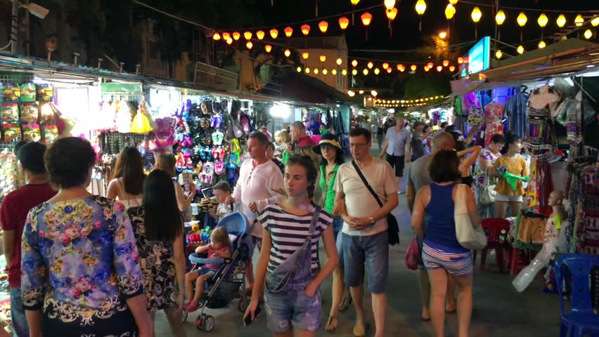 NHA TRANG, VIETNAM - OCTOBER 2017: Night market at Nha Trang city on Tran Phu street. Nha Trang is a popular sea resort in southern Vietnam. Royalty-Free Stock Footage #1013414756