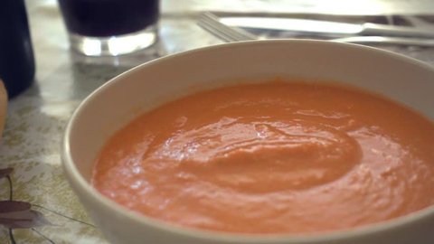 Eating fresh and tasty bowl of Gazpacho.Typical summer cold soup of raw blended vegetables,classic of spanish cuisine.Include tomato, cucumber, bell pepper, onion and garlic, olive oil, wine vinegar.