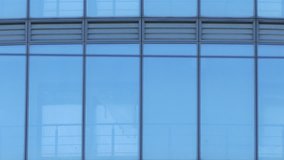 Ungraded: Corporate office building with curtain wall. Vertical panning with acceleration. Ungraded H.264 from camera without re-encoding. (av47214u) - Powered by Shutterstock - Get 15% off with code: PIKWIZARD15