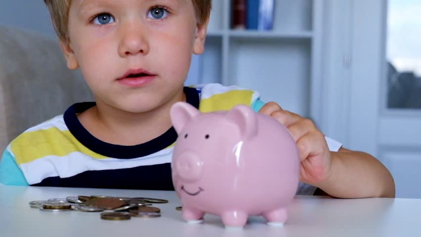 Little Boy Putting Coins in : video 