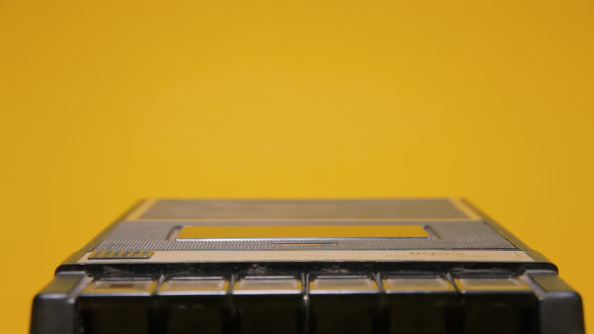Inserting and removing an audio cassette from a retro vintage player. Close-up shot on a yellow background.
 Royalty-Free Stock Footage #1013429147
