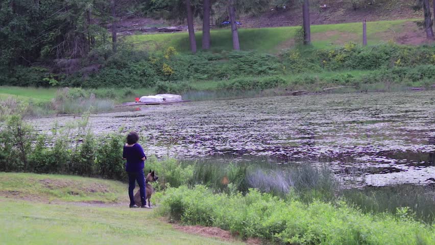 woman an dog at lake