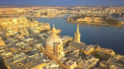 Valletta, Malta - 4K flying around Mount Carmel Basilica and St.Paul's Cathedral at surise