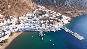 Aerial drone bird's eye view video of picturesque port of Kamares with traditional fishing boats docked, Sifnos island, Cyclades, Greece