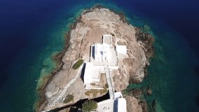 Aerial drone, bird's eye view video of iconic church of Chrysopigi in picturesque island of Sifnos, Cyclades, Greece