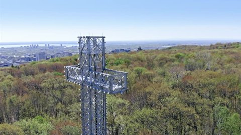 AERIAL: Flying over the cross structure and Montreal city skyline. Quebec, Canada