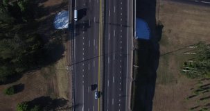 4k aerial drone footage - moving above highway and road junction with traffic. Minsk high road. Cars and trucks move along the route