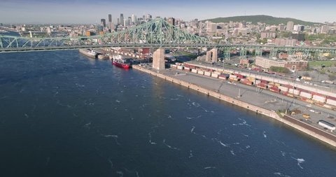 AERIAL: Flying over the railway, Pont Jacques-Cartier bridge, Saint Lawrence River and Montreal Skyline, Quebec, Canada