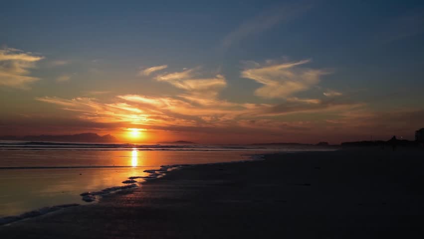 The last bit of sun of the day. Watching the sun set slowly over the ocean just behind Table Mountain, Cape Town, South Africa. The waves rolling in, the day calming down and coming to and end.