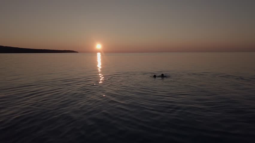 Two friends swimming in Lake Superior, Michigan.