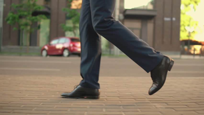 good looking businessman wears fashionable outfit walking to his office. executive gets to his work by foot. Royalty-Free Stock Footage #1013459915