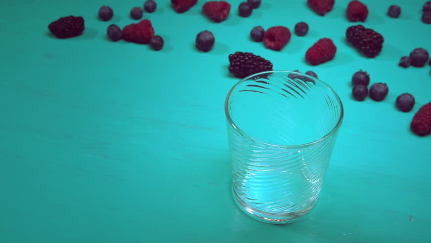 smoothie drink from fruits and berries poured in the cup. delicious viscous beverage on the table with berries.