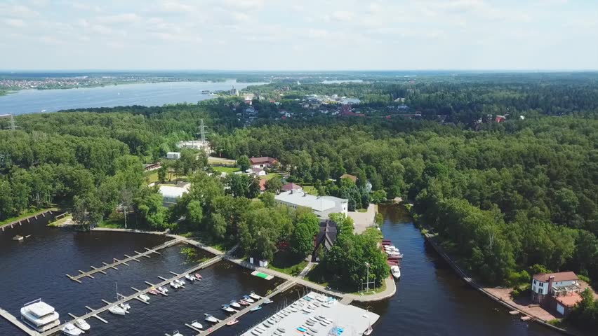 Drone shoot of the river with boats and yachts, a forest, a village and roads