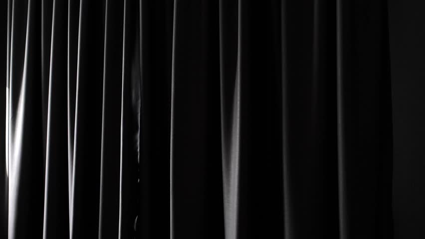 Young woman opens the window curtains