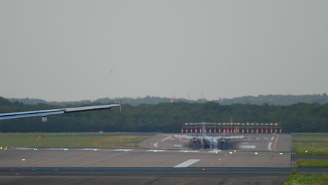 Turboprop airplane landing at sunset. Dusseldorf airport