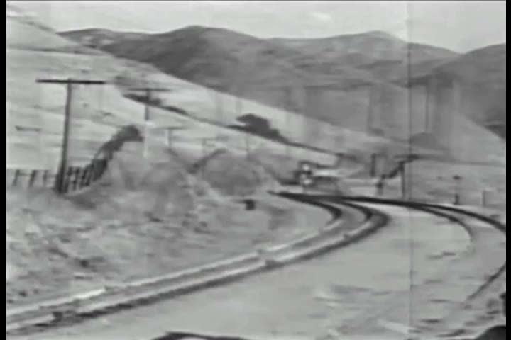 CIRCA 1937 - The Southern Pacific Daylight train passes through coastal mountains Paso Robles.