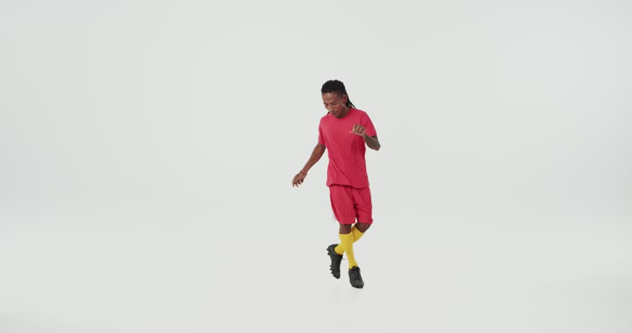 Happy Brazilian football player in red uniform dancing and celebrating victory of his country. Concept of soccer championship, united team match, football game.