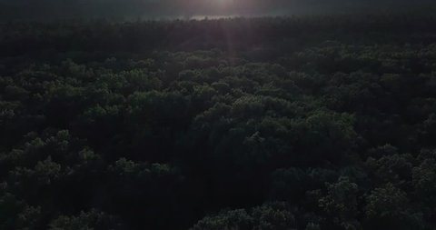 Ariel drone shot of sunset over New England with clouds and fog and trees, Ariel view of fog in trees with sunset in the summer. long panning shot of sunset in New England. 