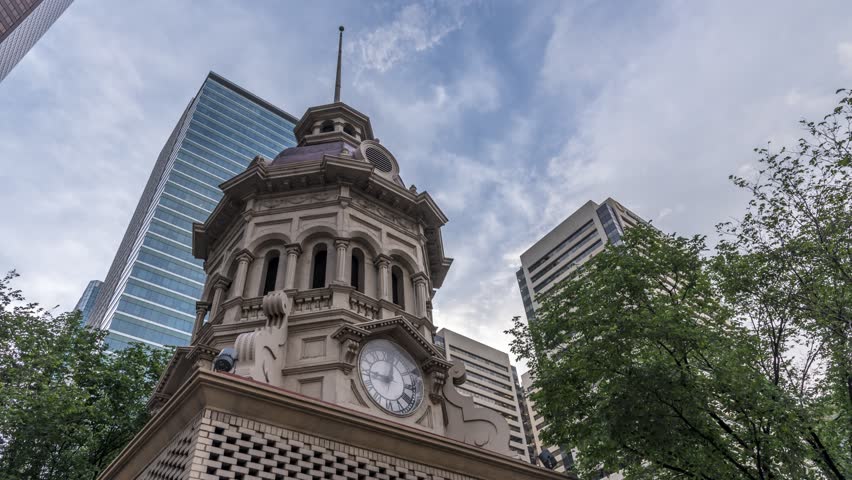 Time-lapse looking up at an old clock tower in downtown Calgary, Alberta, 