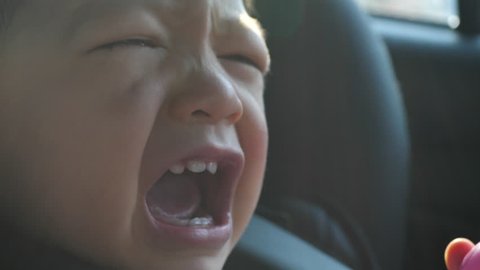 slow motion, baby crying unhappy in car seat